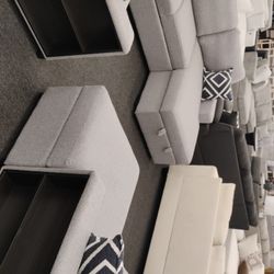 
Modern Gray Sectional Sofa with Built-In Storage and Ottomans