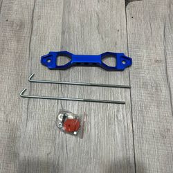 Cusco style car battery tie down holder