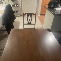 Brown Wooden Table With Four Wood Chairs