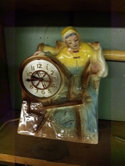 Vintage rare hand painted ceramic ladie on a spinning wheel clock