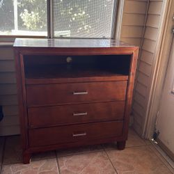 Brown dresser with open cabinet 
