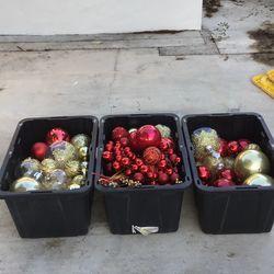 3 large bins of assorted Christmas decorations.
