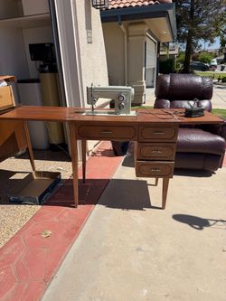 1970s Sears Kenmore sewing machine and table. The sewing machine folds down into the table.