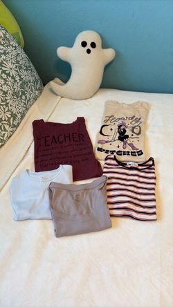 5 T-shirts size medium except burgundy Teacher T-shirt size Large.