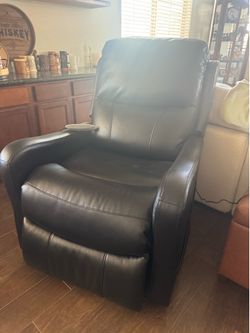 Black reclining chair with remote controls