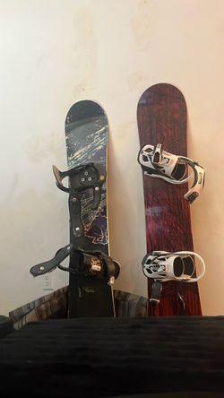 2 snowboards with bindings and a case