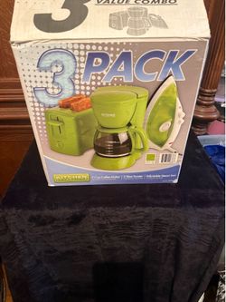 Three piece small electronic set green color new there’s iron a coffee maker and a toast toaster still in the box