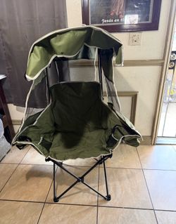 portable folding camping chair with a built-in privacy canopy, designed to provide shade and added seclusion while relaxing outdoors.