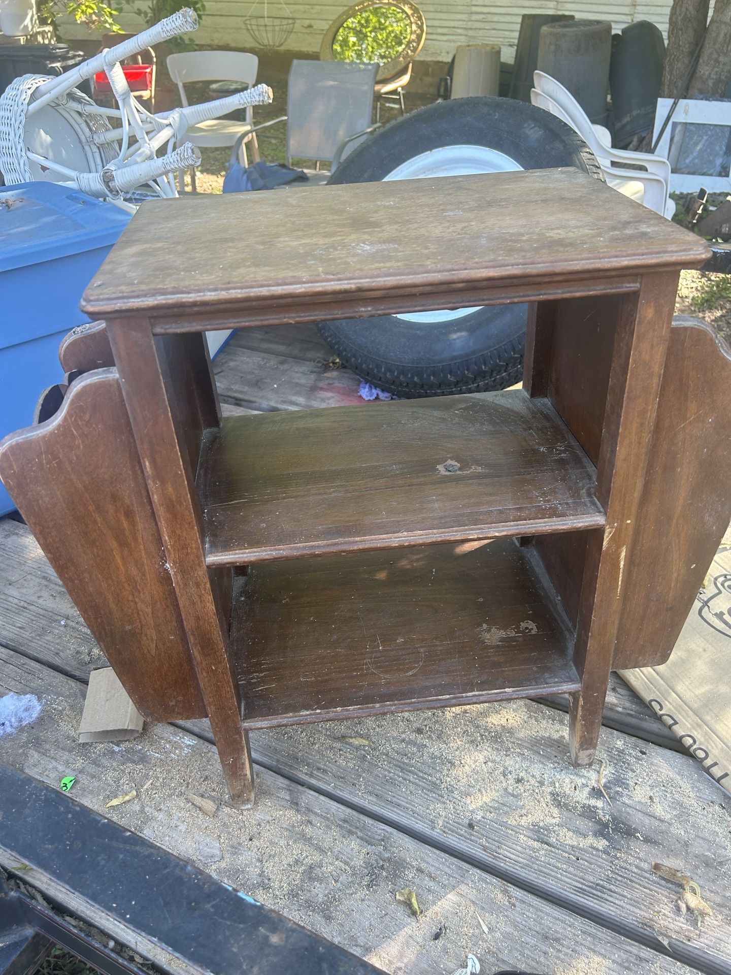 Old magazine rack, needs a good cleaning. It’s 24 inches tall 26 inches wide and 12 inches deep