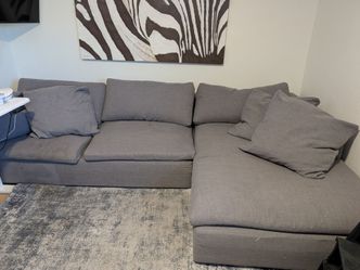Living Spaces Grey Linen 2 Piece Sectional with Right Arm Facing Oversized Chaise.