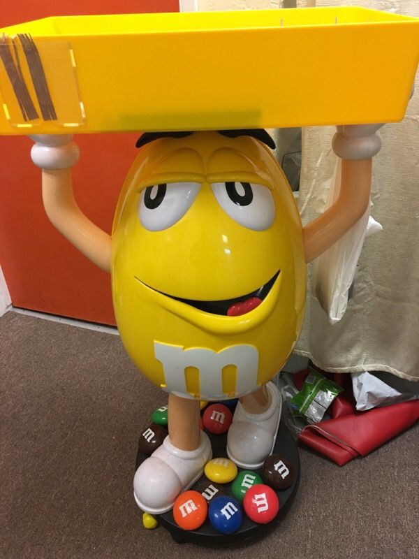 Giant YELLOW M&M Guy holding tray