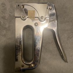heavy-duty manual staple gun, specifically an Arrow Model T-50