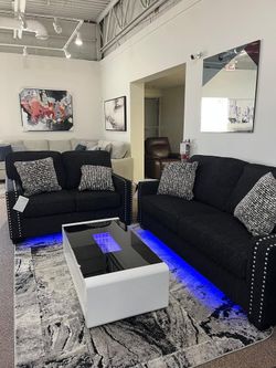 Stunning Sofa set features chic-coal upholstery, nailhead trim, LED light