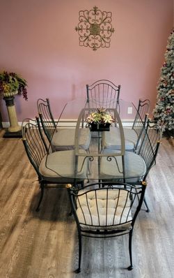 Wrought iron table with glass top and 6 chairs