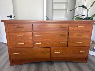wooden dresser with golden knobs