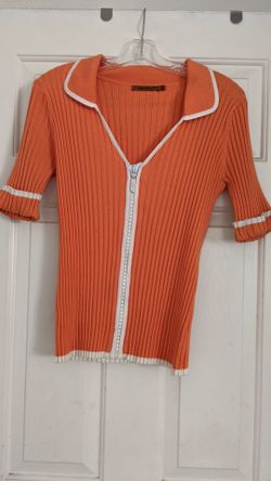 Orange shirt w/ white accents & a rhinestone zipper