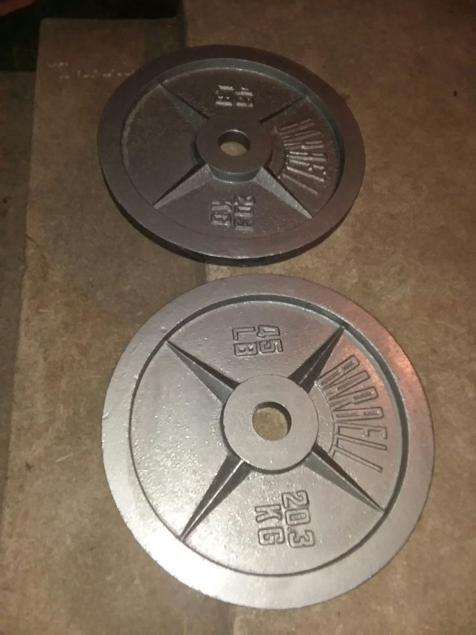A pair of 45Lb Olympic size weight plates. $55 Firm