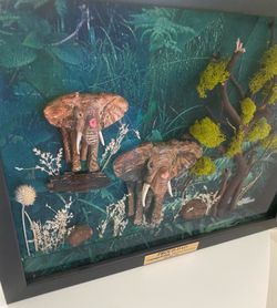 Very unique 1 of a kind 3-D effect beautiful hand sculpted and hand painted mother and baby elephant enclosed in a very expensive shadow box.   Set in