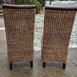 Two Solid wooden chairs with Wicker material seats and backs all in Excellent condition.