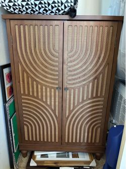 Art deco storage cabinet with woven detail on doors