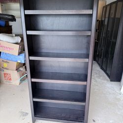 Dark brown wood bookshelf, 11.5” D x 75” H x 33.5 W