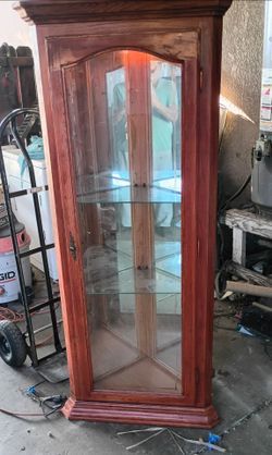 Corner  cabinet. Solid  two glass shelves. Needs to be finished, restained.