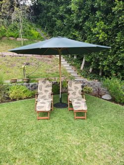 Teak steamer lounge chairs and umbrella.