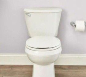 American Standard Reliant Two-Piece 1.28 GPF Single Flush Round Standard Height Toilet with Slow-Close Seat in White