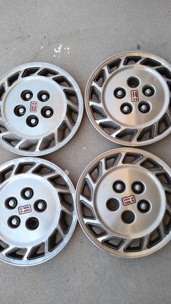 Four 14 inch Oldsmobile wheel covers
