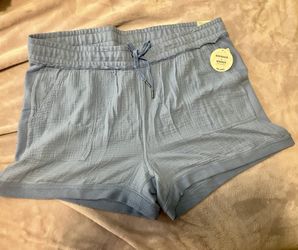 Comfortable women's relaxed shorts with an elastic drawstring waist. Lightweight textured fabric for soft hem for easy movement. Light blue color adds