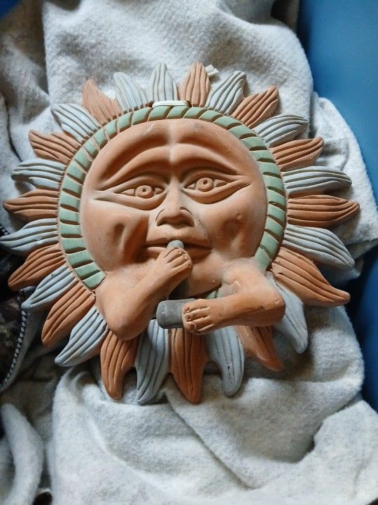 A sun smoking peace pipe