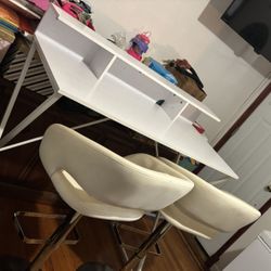 white table with two adjustable barstool chairs 