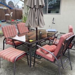 Patio table, chairs, umbrella, umbrella stand, cushions