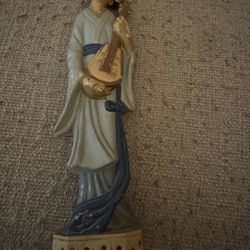 11” plastic asian lady figure with an instrument and 11” asian man