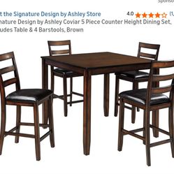 Ashley's Counter Height Table And Chairs 
