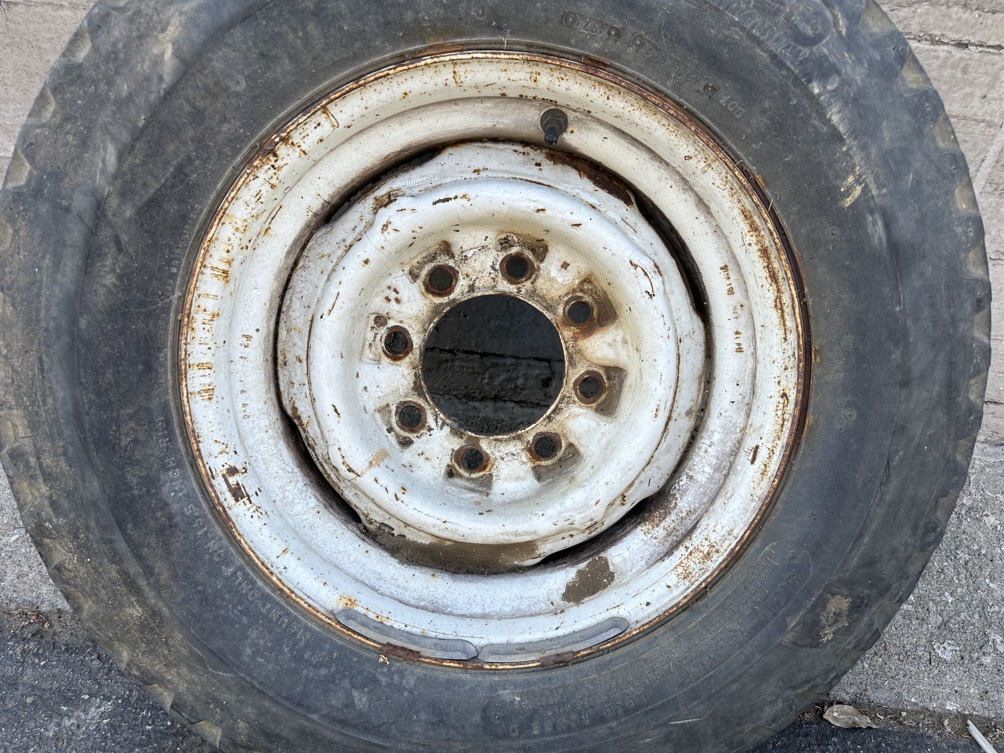 One 8 lug Chevy or GMC 16.5 inch truck wheel and old tire 