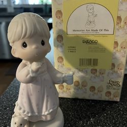Precious moments, several left displayed In cabinet