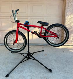 Mongoose Legion L10 BMX bike features a red frame and 20-inch wheels.