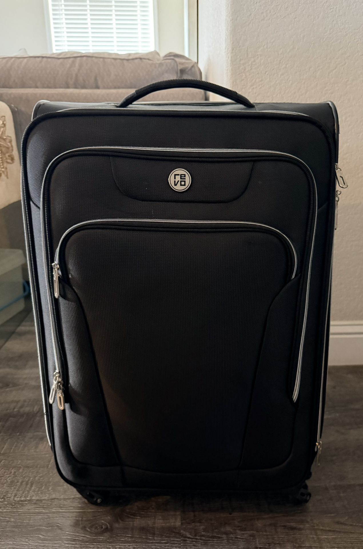 REVO REVO - Black Wheeled Suitcase – Durable & Travel-Ready!