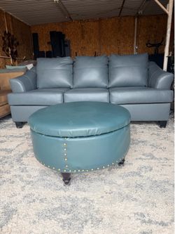 Ashley Genoa Steel sofa features a gray leather match finish and flared arms.