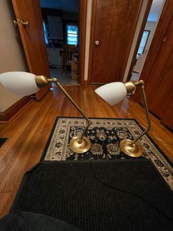 Pair of adjustable brass lamps with white glass shades