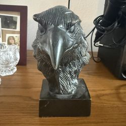 carved solid brass eagle bust on a pedestal base, which is a collectible decorative piece often designed in the style of 1980s or vintage Indian metal