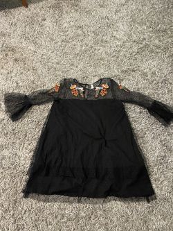 Like new adorable women’s size medium black lace dress with embroidery.
