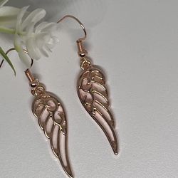 Gold Tone winged earrings.