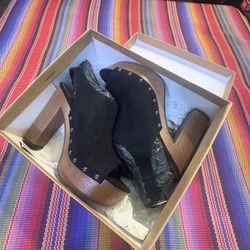 Indigo Rd. "Dani" or a similar style from the brand. They are black suede platform sandals with a wooden heel and stud detailing. 