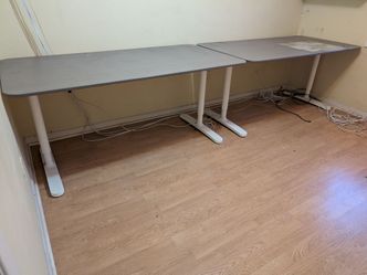 Two IKEA adjustable height tables