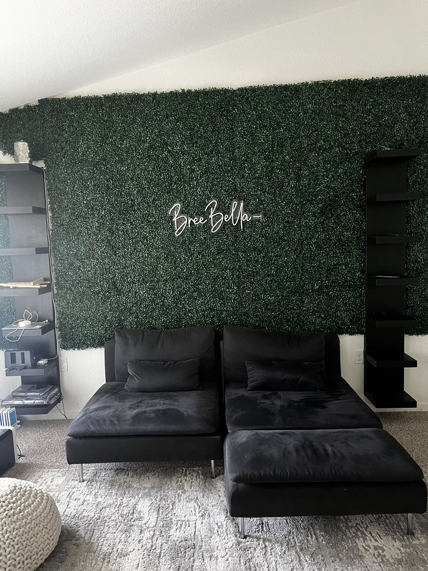 black shelving and grass wall