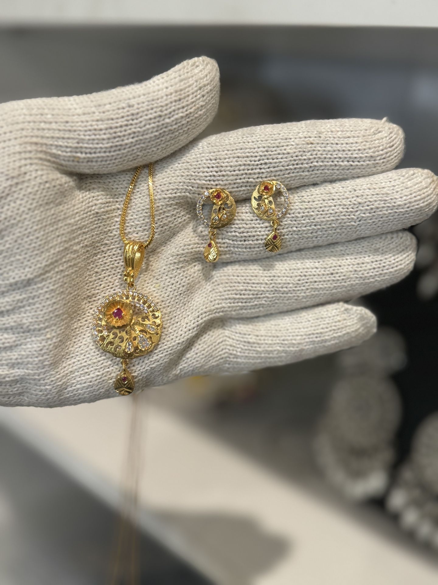 gold plated locket set with studs and ad stone