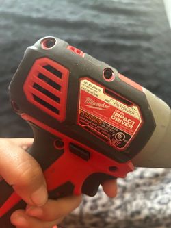Two Milwaukee drills with a Milwaukee bag