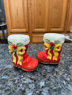 Ceramic Christmas Santa Claus Boots Pair of Salt and Pepper with Yellow Bow And Holly. Preowned. Has been on display in a cabinet with a very large